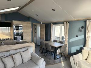 a living room with a couch and a table at 7A Dolphin Point in Ashington