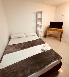 Rúm í herbergi á Hotel Coffee Real Pereira