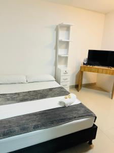 Rúm í herbergi á Hotel Coffee Real Pereira