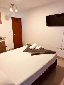 Rúm í herbergi á Hotel Coffee Real Pereira