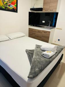 Rúm í herbergi á Hotel Coffee Real Pereira