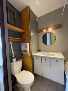 a bathroom with a toilet and a sink at Dome De Polset Condo by AlpStays in Val Thorens