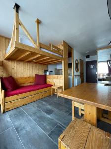 a room with benches and a table in a room at Dome De Polset Condo by AlpStays in Val Thorens