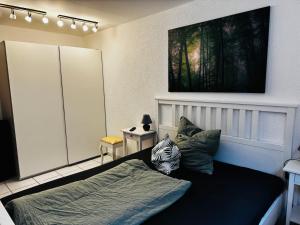 a bedroom with a bed and two pillows at Landleben pur in Mühlacker
