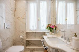 a bathroom with a sink and a toilet and a mirror at Casa e Arte in Sorrento +17 photos