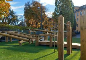 a group of wooden benches in a park at Crafoord Place Hostel in Stockholm
