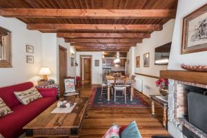 a living room with a red couch and a fireplace at Roca Blanca by Totiaran in Naut Aran