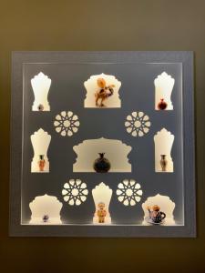 a framed picture of some figurines on a wall at Daro Boutique in Bukhara
