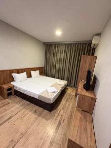 a bedroom with a bed and a television in it at Radi Inn in Svilengrad