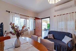 a living room with a table and a couch at Holiday Home Gradina, Island of Korčula in Vela Luka