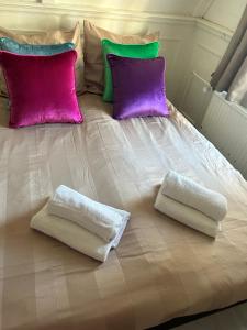 a bed with two pillows and two towels on it at Cosy by Mandy in Amsterdam +6 photos