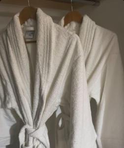 a group of white towels hanging on a rack at Thrumster Lodges - 3 Luxurious Self Catering Lodges on the NC500, 2 with Hot Tubs in Wick