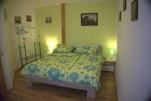 a bedroom with a bed and two night stands and two lamps at VIK Apartement in Kolonie Eichenweiler +20 photos