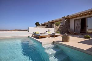 a villa with a swimming pool and a patio at Hotel Milos Sea Resort in Adamantas