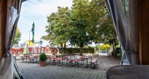 - un groupe de tables et de chaises dans une cour dans l'établissement Jagerhof, à Garching bei München