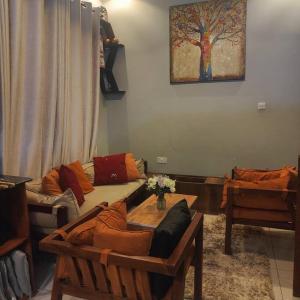 a living room with a couch and a table at Cherry Homes in Dar es Salaam