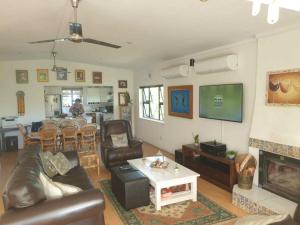a living room with a couch and a table at Paradise in Plettenberg Bay in Plettenberg Bay