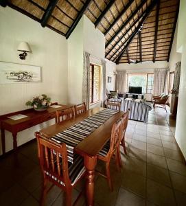 a dining room with a wooden table and chairs at Kruger Park Lodge - Unit 522 , Hazyview in Hazyview