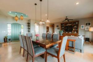 a dining room and living room with a table and chairs at Casa de las Olas - Villa Ocean View in San José del Cabo +32 photos
