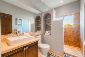 a bathroom with a sink and a toilet and a shower at Casa de las Olas - Villa Ocean View in San José del Cabo