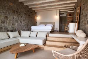 a living room with a couch and a bed at Hotel Milos Sea Resort in Adamantas