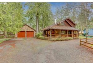 a large house with a garage and a barn at Alpine Cabin in Rhododendron