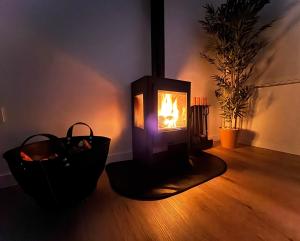 a wood stove with a fire in a room at San Xuan Resort in San Juan de Nieva