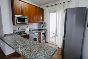 a kitchen with a refrigerator and a stove top oven at Alojamiento Sierra Cazorla in La Iruela +13 photos