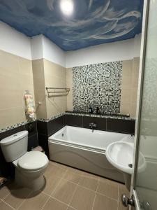 a bathroom with a toilet and a tub and a sink at Crab Bui Vien Homestay in Ho Chi Minh City