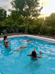 two people swimming in a swimming pool at Villa Mohana in Puerto Colombia