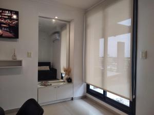 a living room with a window and a couch at "REFUGIO EN LA TERRAZA" - WiFi 300mbs in Santiago del Estero