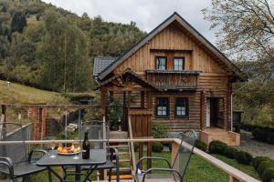 a log cabin with a table and chairs at Rakhiv House in Rakhiv