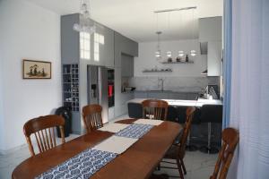 a kitchen and dining room with a table and chairs at Garden Hill Villa Durres in Durrës