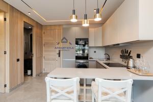 a kitchen with a white table and white chairs at Bright Spacious Suite- By Appart'Ayla in Casablanca