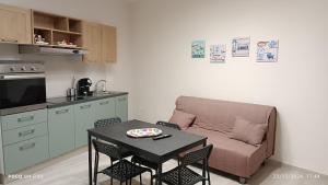 a living room with a table and a couch at Grotthouse in Andria
