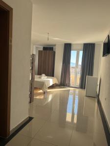 a bedroom with a bed and a large window at Hotel Palace Struga in Struga