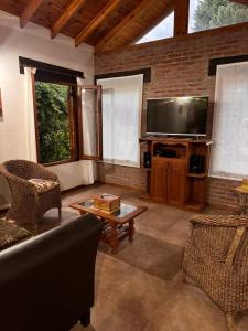 a living room with a couch and a flat screen tv at OKIN 6 La Emperatriz in Costa del Este