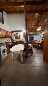 a kitchen with a white table in the middle of a room at OKIN 6 La Emperatriz in Costa del Este