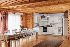 a kitchen with a table and chairs in a room at Rakhiv House in Rakhiv