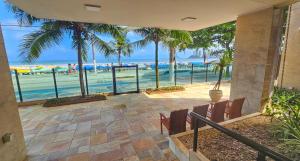 a view of the beach from the balcony of a house at Linda Vista do Mar - Espaçoso - Praia Pitangueiras in Guarujá