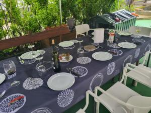 a purple table with plates and wine glasses on it at Zubizar in Morga