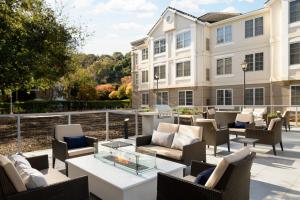a patio with chairs and tables and a building at Residence Inn Pleasanton in Pleasanton +62 photos