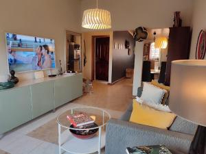 a living room with a couch and a table at Oheneba Tema - Luxury Hot -Tub Retreat with Wi-Fi in Tema