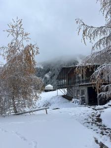 a house covered in snow in front at Ethno complex Ala kush in Kaindy