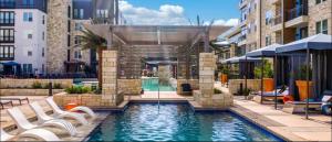 a swimming pool with chairs and a fountain in a building at Luxury Appartement with Everything in Addison