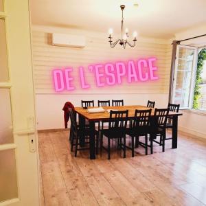 a dining room with a table and a pink sign at Ateka Dax in Dax