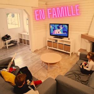 a group of people sitting in a living room watching tv at Ateka Dax in Dax