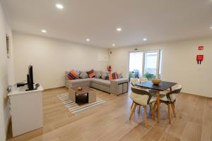 a living room with a couch and a table at Casa da adega in Lamas de Olo