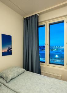 a bedroom with a bed and a window at Transit Rooms & Sauna Airport Hostel in Vantaa