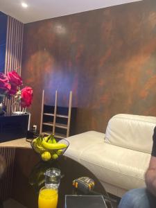 a room with a bed and a bowl of bananas on a table at Ronza in Abidjan